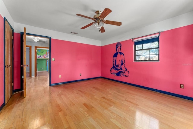 unfurnished room with baseboards, visible vents, ceiling fan, and light wood finished floors