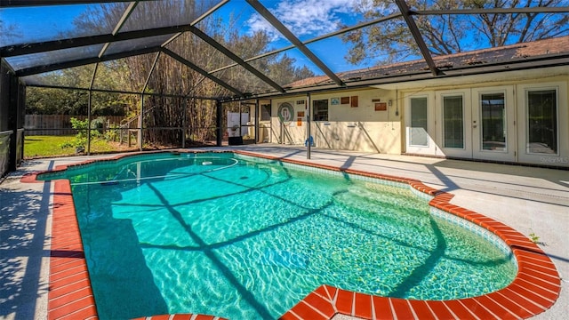 view of pool with a fenced in pool, a patio, glass enclosure, fence, and french doors