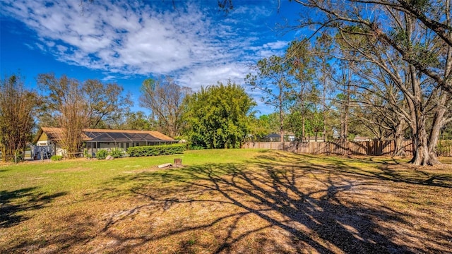 view of yard featuring a lanai and fence