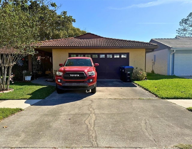 ranch-style house featuring driveway, a tiled roof, and stucco siding