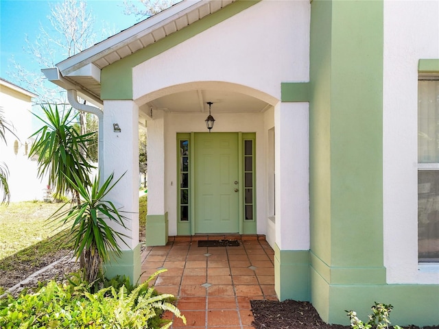 doorway to property with stucco siding