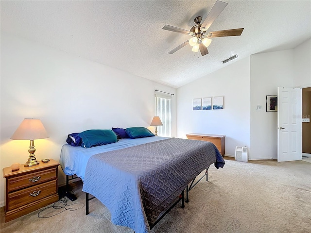 bedroom featuring visible vents, light colored carpet, vaulted ceiling, a textured ceiling, and a ceiling fan