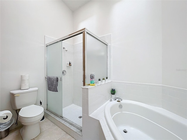 bathroom featuring a garden tub, toilet, a stall shower, and tile patterned floors