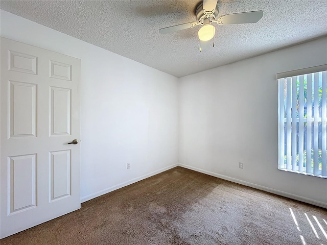 carpeted empty room with baseboards, a textured ceiling, and a ceiling fan