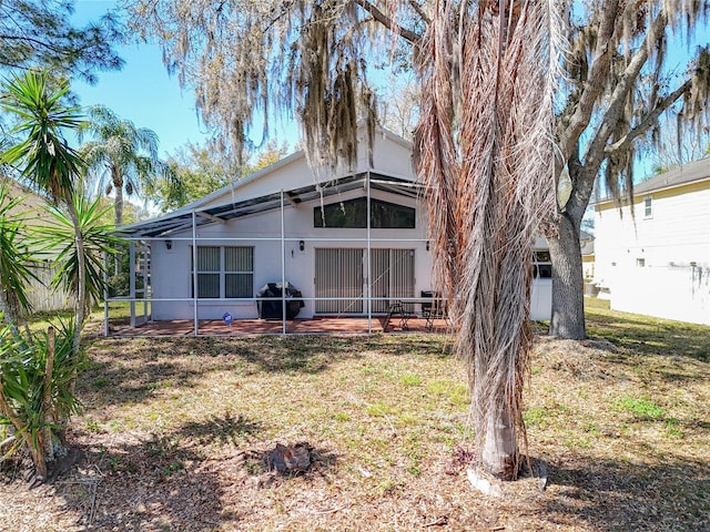 back of house with a patio area, glass enclosure, and fence