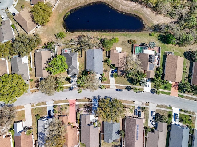 drone / aerial view with a residential view and a water view