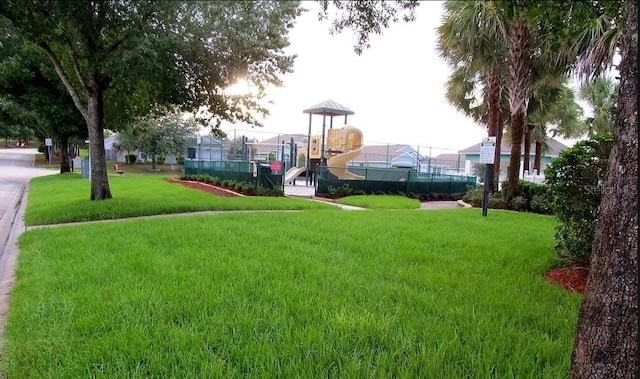 surrounding community with a lawn and fence