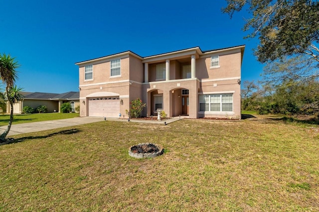 view of front of house with a garage, driveway, a front lawn, and stucco siding