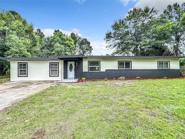 single story home with brick siding and a front yard