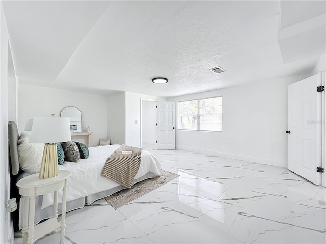 bedroom with marble finish floor, visible vents, baseboards, and a textured ceiling