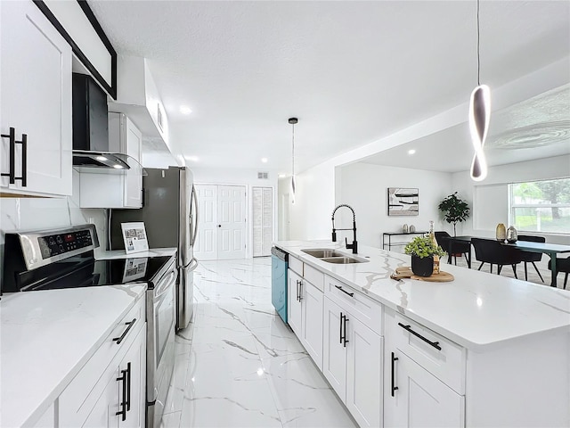 kitchen with a sink, white cabinetry, marble finish floor, wall chimney range hood, and appliances with stainless steel finishes