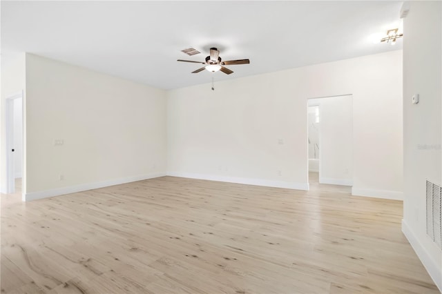 unfurnished room with baseboards, light wood-style flooring, visible vents, and a ceiling fan