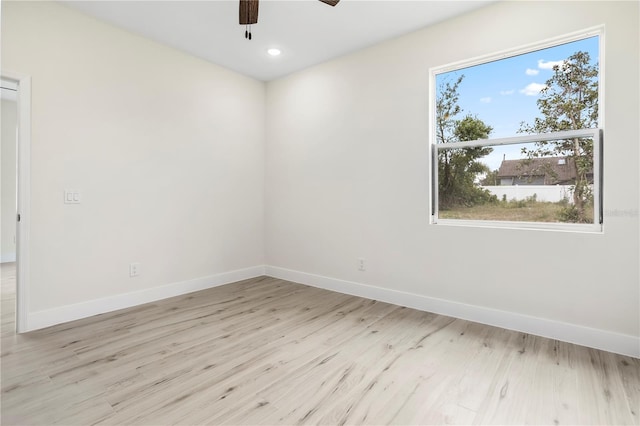 spare room with light wood-type flooring, baseboards, a ceiling fan, and recessed lighting