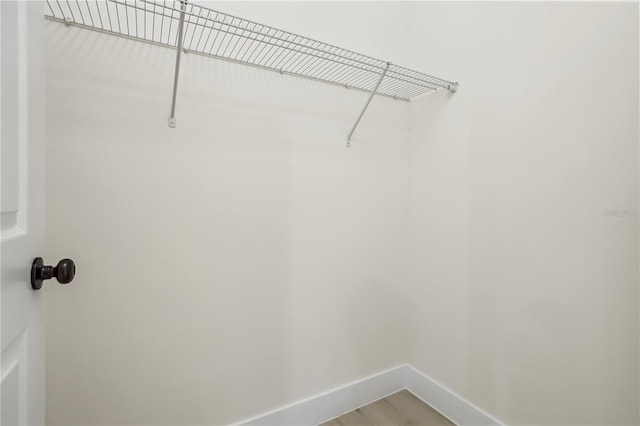 walk in closet featuring wood finished floors