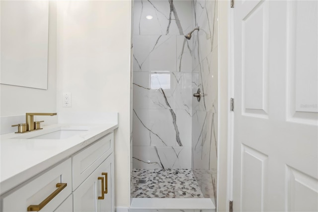 full bathroom featuring vanity and a marble finish shower