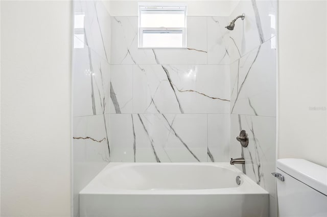 bathroom with tub / shower combination and toilet