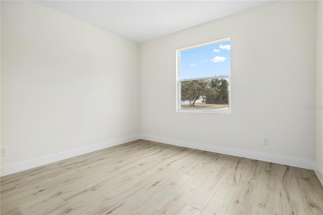 empty room with wood finished floors and baseboards