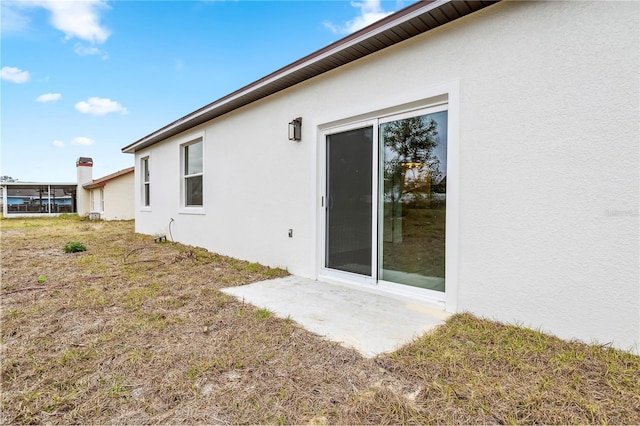 rear view of property with stucco siding