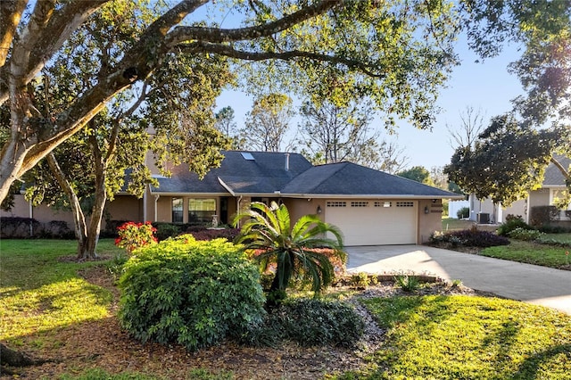 ranch-style home with an attached garage, central air condition unit, concrete driveway, stucco siding, and a front lawn