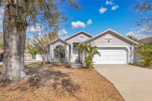 single story home featuring concrete driveway and an attached garage