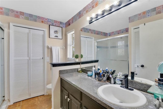 102 Ethan Ave, Davenport, FL 33897 - full bathroom featuring a closet, a shower stall, vanity, and tile patterned flooring
