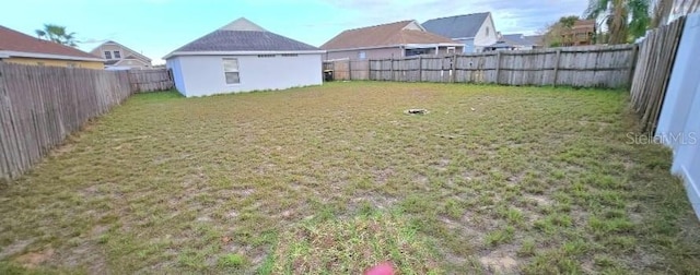 view of yard with a fenced backyard