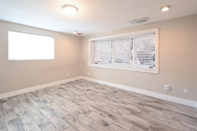 empty room featuring wood finished floors and baseboards