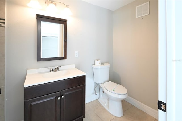 bathroom with tile patterned flooring, toilet, vanity, visible vents, and baseboards