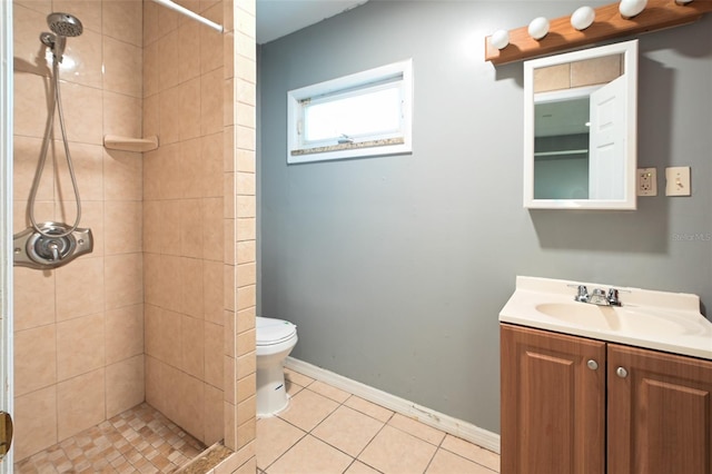 full bathroom featuring toilet, a shower stall, vanity, and tile patterned floors