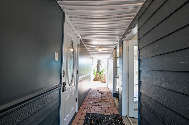 hallway featuring brick floor