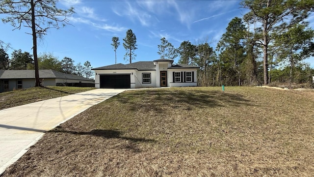 prairie-style home with a garage, a front yard, concrete driveway, and stucco siding