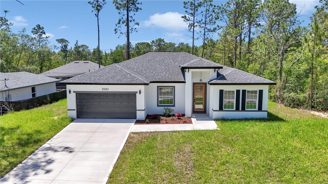 view of front of property with a front lawn, stucco siding, a shingled roof, concrete driveway, and an attached garage