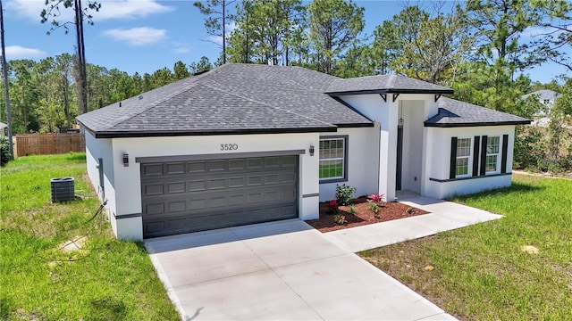 ranch-style house with a front yard, an attached garage, roof with shingles, and stucco siding