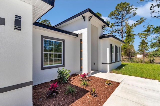 property entrance featuring stucco siding