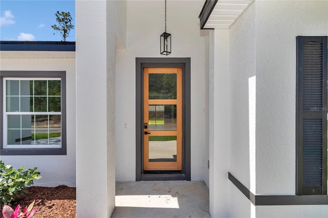 property entrance featuring stucco siding