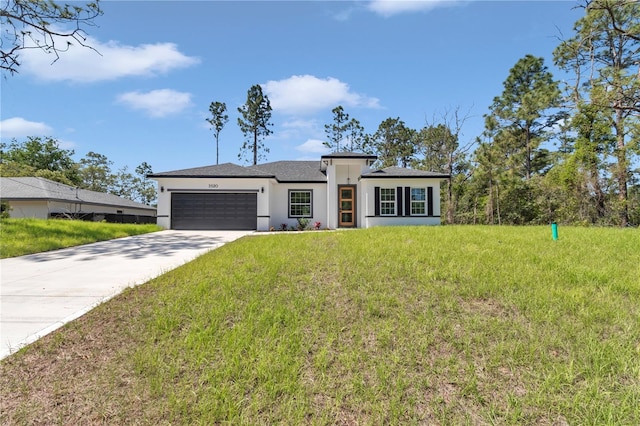 prairie-style home with a garage, a front lawn, stucco siding, and driveway