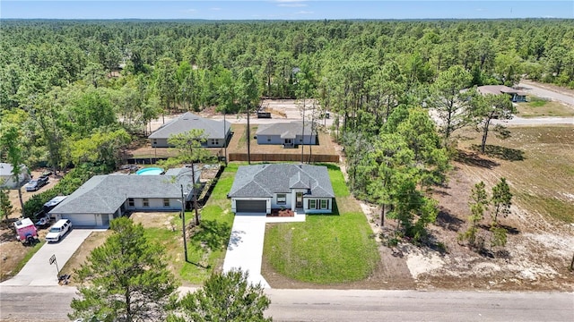 bird's eye view featuring a wooded view