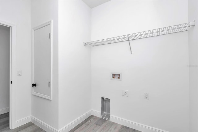 washroom with washer hookup, laundry area, baseboards, electric dryer hookup, and light wood-type flooring