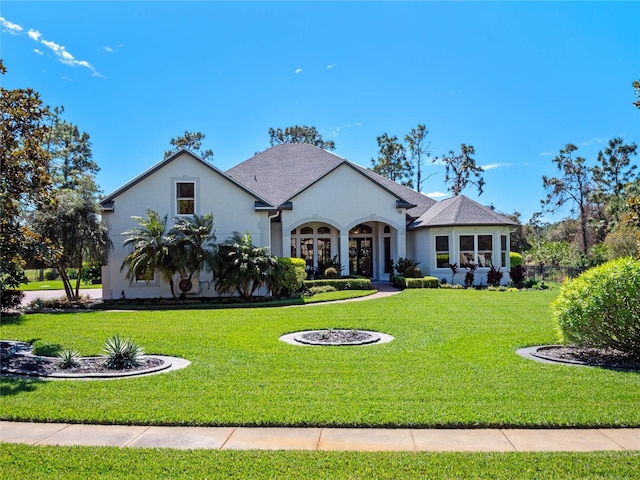 view of front of property with stucco siding and a front yard