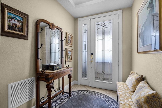 entrance foyer featuring baseboards, visible vents, and light tile patterned flooring