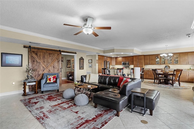 living room with a textured ceiling, a barn door, light tile patterned flooring, and crown molding