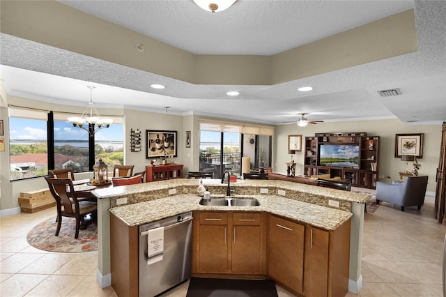 kitchen with a center island with sink, visible vents, brown cabinets, stainless steel dishwasher, and a sink