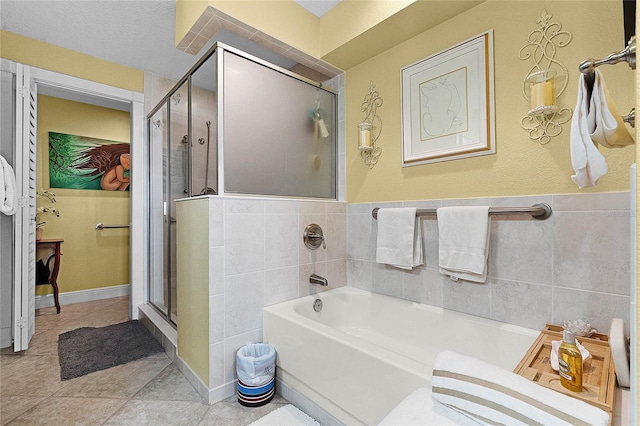 full bath featuring a bath, a shower stall, tile walls, and tile patterned floors