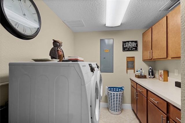 laundry room featuring cabinet space, electric panel, visible vents, a textured ceiling, and washer and dryer