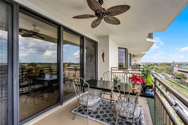 balcony with a ceiling fan and a sunroom