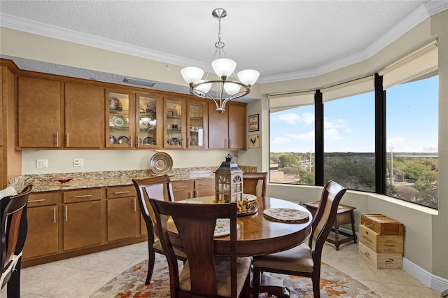 dining room with ornamental molding, visible vents, a notable chandelier, and light tile patterned floors