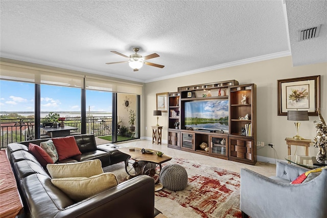 tiled living room featuring crown molding, a textured ceiling, visible vents, and a ceiling fan