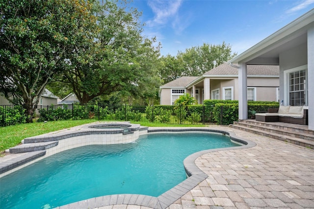 view of pool with a patio area, a pool with connected hot tub, and a fenced backyard