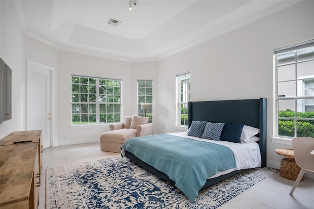 bedroom featuring a tray ceiling, crown molding, and visible vents