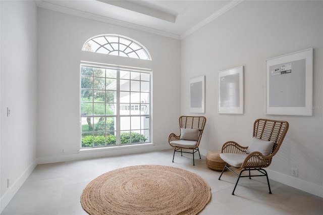 living area featuring baseboards and ornamental molding